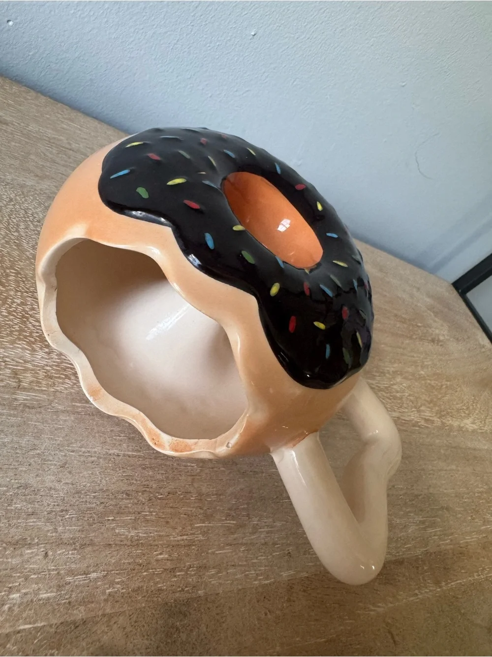 Donut-Shaped Ceramic Mug with Black Frosting and Tan Body